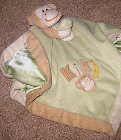 Blankets and Beyond Tan Monkey Holding Green Blankie with Tan Binding
