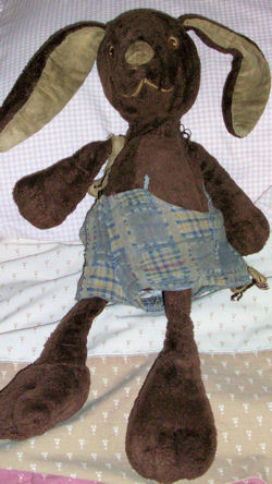 Long Legged Brown Rabbit wearing Blue Patchwork Shorts with Suspenders
