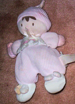 Oshkosh Brown Haired Doll wearing a Thermal Knit Sleeper and Bunny Slippers