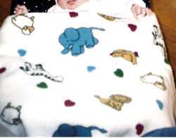 White Baby Receiving Blanket with Blue Elephants, Yellow Giraffes, and Sheep